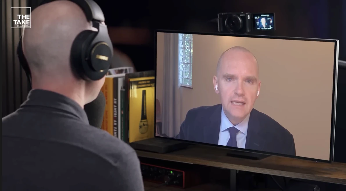 Bob Kitchen speaking remotely with the host of Al Jazeera's The Take